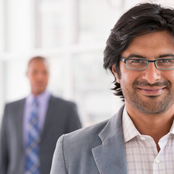 New York City June,USA,A business environment, a light airy city office. Business people. A man in a light jacket wearing glasses.