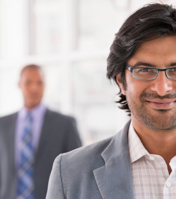 New York City June,USA,A business environment, a light airy city office. Business people. A man in a light jacket wearing glasses.