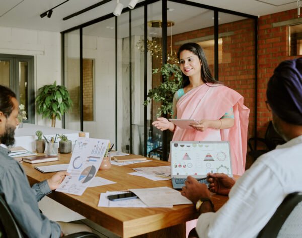Female Colleague Speaking to Coworkers