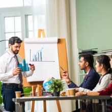 group-of-businesspeople-looking-at-young-indian-as-2024-06-03-22-32-05-utc